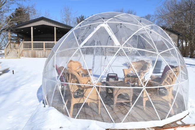 Black Fire Winery and brewery outdoor seating including a covered porch and clear igloos out behind the tasting room in Tecumseh.