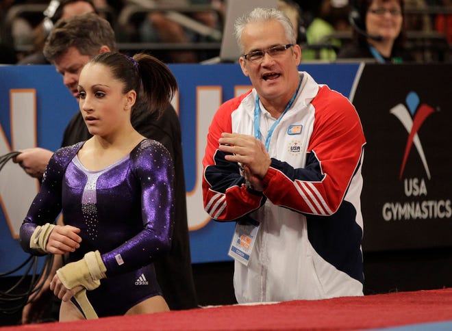 Women's All-Around champion Jordyn Wieber left is shown with her coach John Geddert during the American Cup gymnastics meet at Madison Square Garden in New York, Saturday, March 3, 2012.