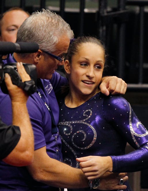 Jordyn Wieber, right, is congratulated by her coach John Geddert, left, after competing in her final event in the final round of the U.S. gymnastics championships, Saturday, Aug. 20, 2011, in St. Paul, Minn. Wieber won the All-Around title.