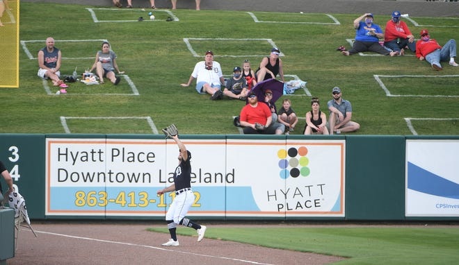 Fans watch as Tigers non-roster left fielder Jacob Robson about to make a running catch in the seventh inning.