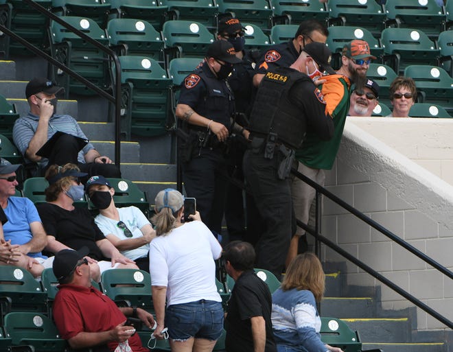 Lakeland police officers remove an unruly fan from the game in the last inning.  Detroit Tigers vs Philadelphia Phillies at Joker Marchant Stadium in Lakeland, Fla. on Feb. 28, 2021.  Tigers win, 10-2.
