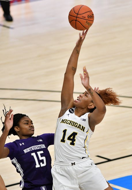 Michigan guard Akienreh Johnson (14) puts up a shot against Northwestern forward Courtney Shaw (15) in the second half.