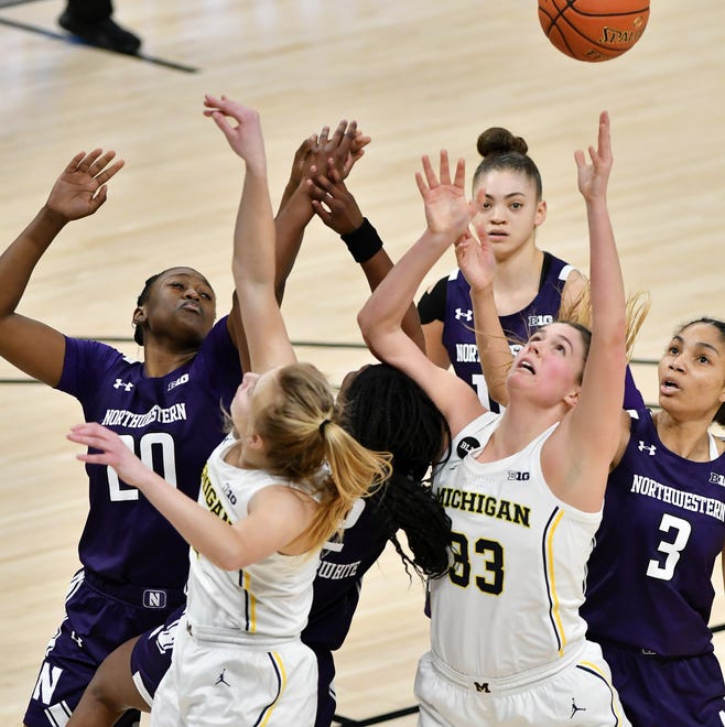 Michigan forward Emily Kiser (33) goes for a rebound in front of Northwestern guard Sydney Wood (3) in the second half.