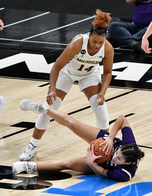 Michigan guard Akienreh Johnson (14) watches as Northwestern guard Veronica Burton (12) comes up with the ball in the second half.