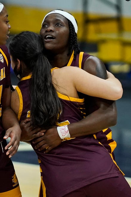 Central Michigan's Micaela Kelly is hugged by a teammate after the victory.