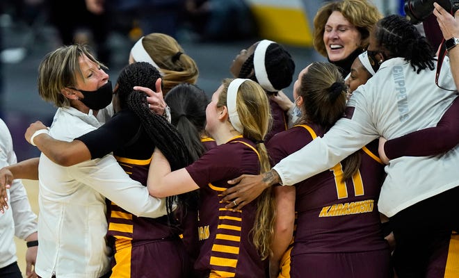 Central Michigan head coach Heather Oesterle, left, celebrates with her team.