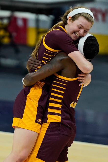 Central Michigan's Molly Davis, left, is hugged by Micaela Kelly after Central Michigan beat Bowling Green, 77-72, to win the Mid-American Conference tournament championship Saturday, March 13, 2021, at Rocket Mortgage Fieldhouse in Cleveland.