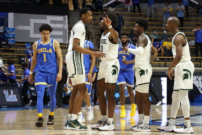 Aaron Henry (0) of the Michigan State Spartans speaks with teammates between plays against the UCLA Bruins during the second half.