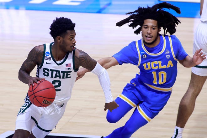 Rocket Watts (2) of the Michigan State Spartans drives to the basket against Tyger Campbell (10) of the UCLA Bruins during the first half.