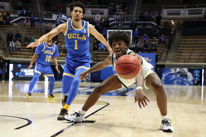 Aaron Henry (0) of the Michigan State Spartans reaches for a loose ball against the UCLA Bruins during overtime in the First Four game.