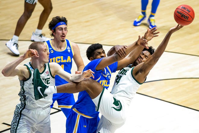 Michigan State's Julius Marble II (34) competes for a rebound with UCLA's Cody Riley, center, next to Michigan State's Joey Hauser, left, and UCLA's Jaime Jaquez Jr. (4) during the first half.