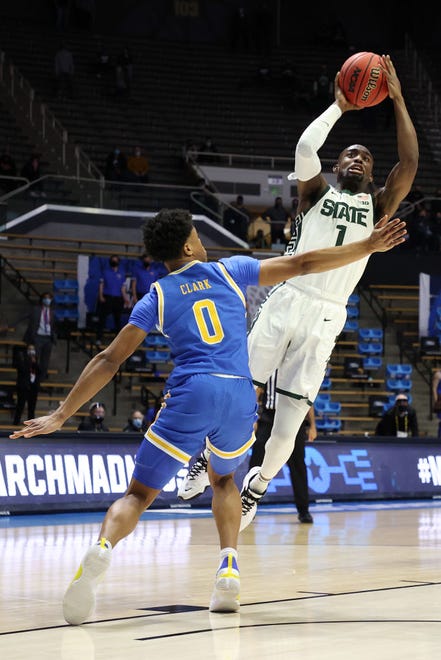 Joshua Langford (1) of the Michigan State Spartans attempts the jump shot over Jaylen Clark (0) of the UCLA Bruins during overtime.