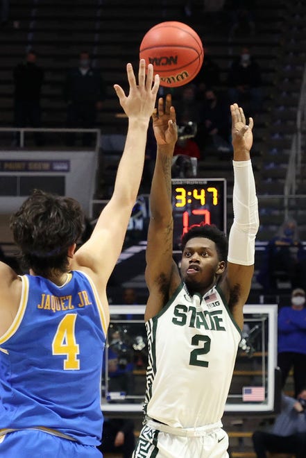 Rocket Watts (2) of the Michigan State Spartans shoots the ball against the UCLA Bruins during overtime.