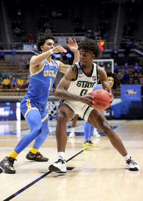 Aaron Henry (0) of the Michigan State Spartans attempts to drive past Jules Bernard (1) of the UCLA Bruins during the second half.