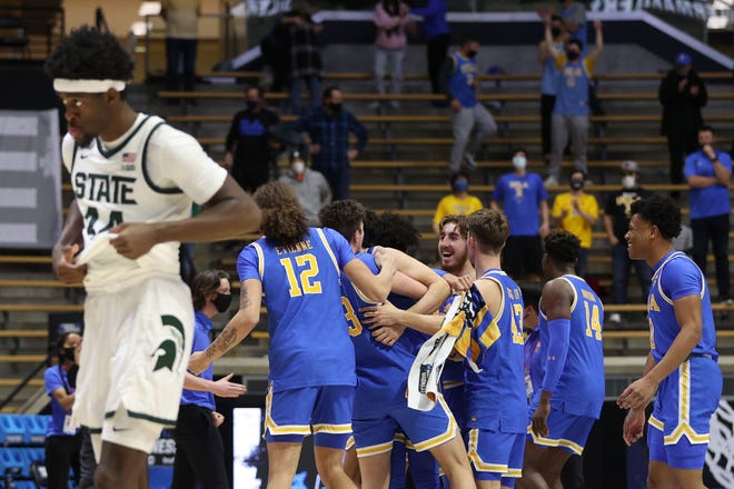 UCLA Bruins players celebrate after defeating the Michigan State Spartans in the First Four game prior to the NCAA Tournament at Mackey Arena on Thursday, March 18, 2021 in West Lafayette, Indiana.