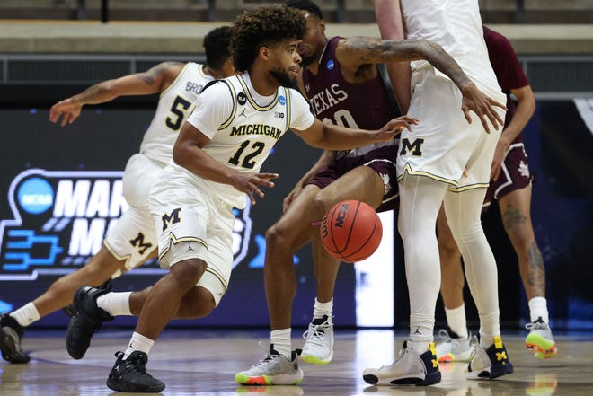 Mike Smith (12) of the Michigan Wolverines drives to the basket during the first half against the Texas Southern Tigers in the first round game of the 2021 NCAA Men's Basketball Tournament at Mackey Arena on March 20, 2021 in West Lafayette, Indiana.