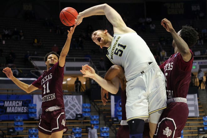 Austin Davis (51) of the Michigan Wolverines loses control of the ball as Jordan Gilliam (11) of the Texas Southern Tigers reaches on during the second half.