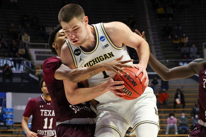 Hunter Dickinson (1) of the Michigan Wolverines drives to the basket against John Walker III (24) of the Texas Southern Tigers during the second half.