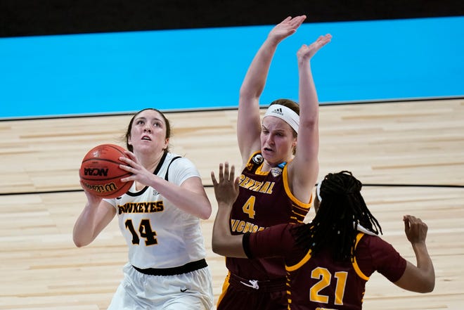 Iowa guard McKenna Warnock (14) drives to the basket ahead of Central Michigan guard Maddy Watters (4) and center Jahari Smith (21) during the second half.