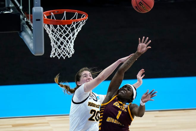 Central Michigan guard Micaela Kelly (1) fights for a rebound with Iowa guard Kate Martin (20).