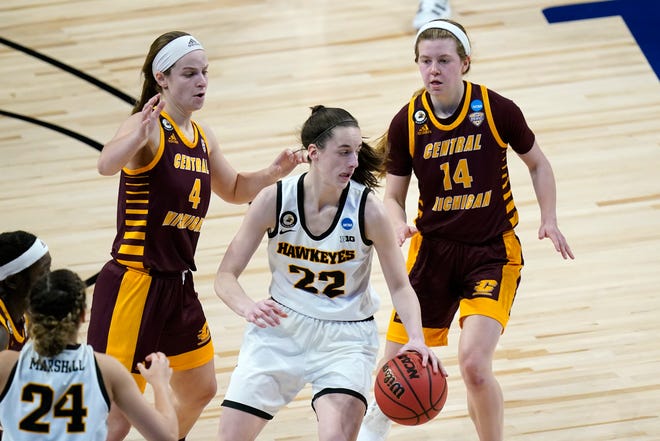 Iowa guard Caitlin Clark (22) drives ahead of Central Michigan guard Maddy Watters (4) and guard Molly Davis (14) during the second half.
