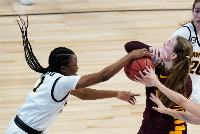 Iowa guard Tomi Taiwo, left, tries to steal the ball from Central Michigan forward Kyra Bussell.
