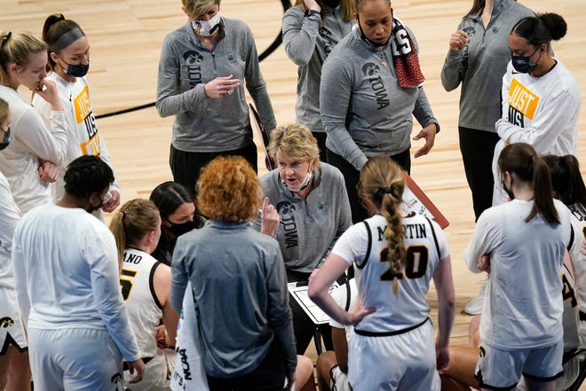 Iowa head coach Lisa Bluder talks to her team during a timeout in the first half.