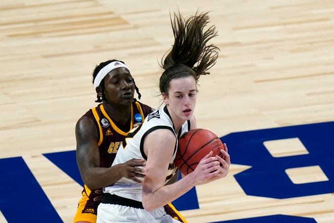 Central Michigan guard Micaela Kelly, left, tries to steal the ball from Iowa guard Caitlin Clark.