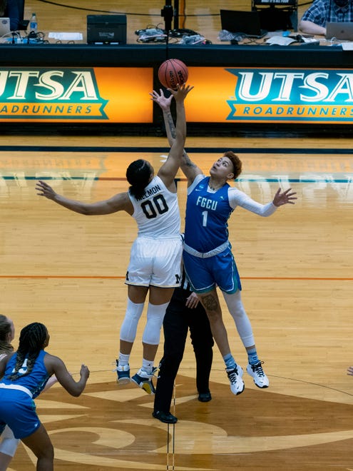 Michigan forward Naz Hilmon (00) jumps the opening tip-off against Florida Gulf Coast guard Kierstan Bell (1) during the first quarter of a college basketball game in the first round of the women's NCAA tournament at the University of Texas San Antonio Convocation Center in San Antonio, Texas, Sunday March 21, 2021.