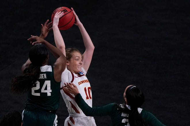 Iowa State guard Kylie Feuerbach (10) looks to pass under pressure from Michigan State guards Nia Clouden (24) and Alyza Winston.