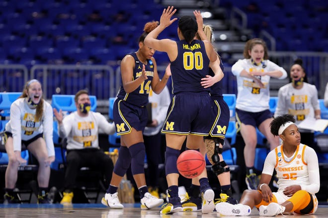 Michigan's Akienreh Johnson (14) and Naz Hillmon (00) celebrate a call ahead of Tennessee's Jordan Horston (25) during the first half.