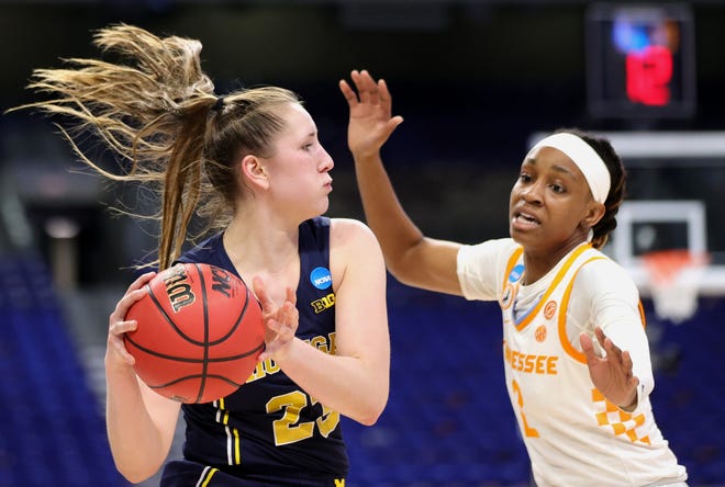 Michigan's Danielle Rauch (23) looks to pass ahead of Tennessee's Destiny Salary (2) during the first half.