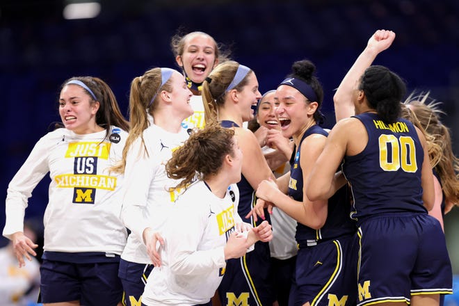 The Michigan Wolverines celebrate after defeating the Tennessee Lady Vols, 70-55, in the second round game of the 2021 NCAA Women's Basketball Tournament at the Alamodome on March 23, 2021 in San Antonio, Texas.