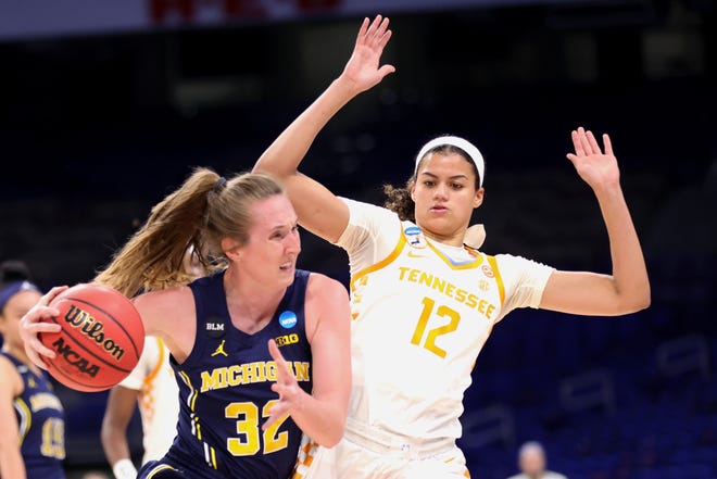 Michigan's Leigha Brown (32) drives against Tennessee's Rae Burrell (12) during the first half.