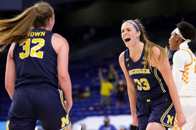 Michigan's Emily Kiser (33) and Leigha Brown (32) react during the first half.