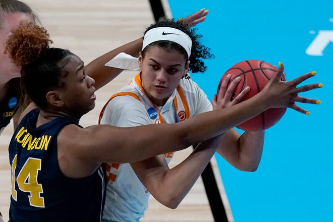 Michigan guard Akienreh Johnson (14) pressures Tennessee guard Rae Burrell during the first half of their game in the second round of the women's NCAA tournament at the Alamodome in San Antonio, Tuesday, March 23, 2021.