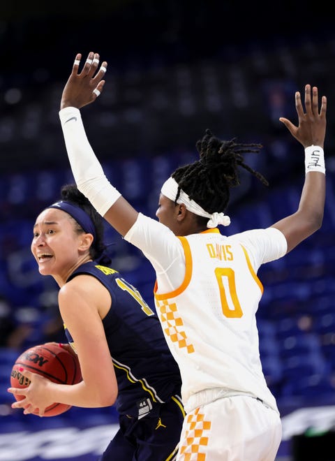 Michigan's Hailey Brown (15) looks to pass ahead of Tennessee's Rennia Davis (0) during the first half.