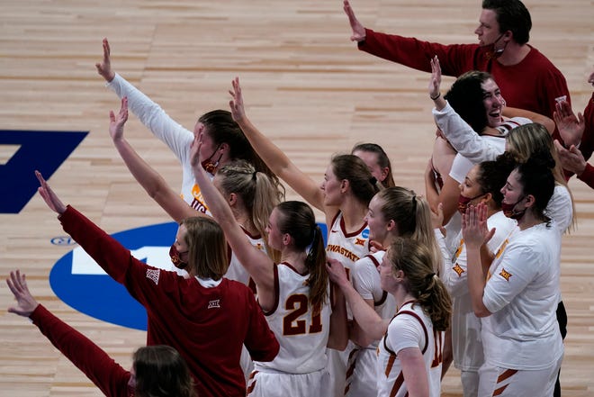 Iowa State players wave to their opponents after their win over Michigan State.