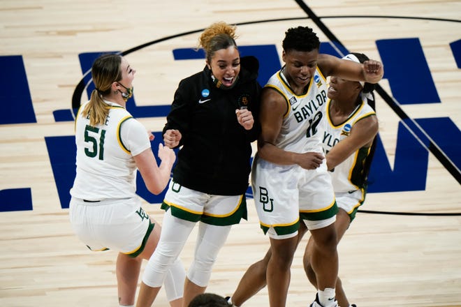 Baylor players celebrate after after beating Michigan, 78-75.