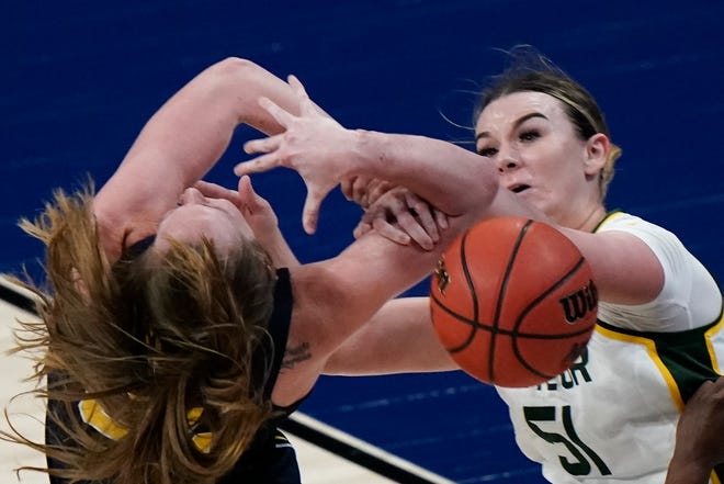 Baylor's Caitlin Bickle knocks the ball from Michigan's Leigha Brown.