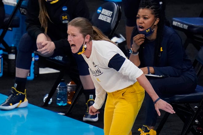 Michigan head coach Kim Barnes Arico calls to her players during the first half.