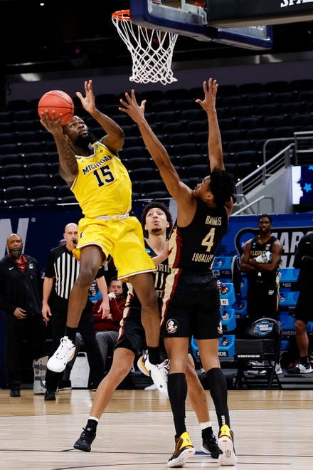 Michigan's Chaundee Brown goes up for a shot against in the first half.