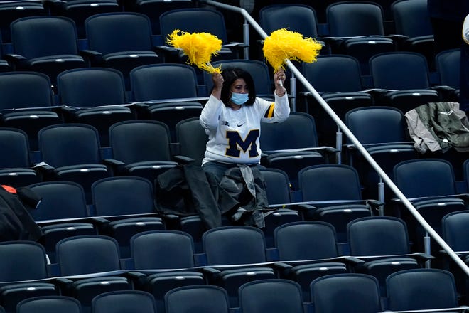 A Michigan fan cheers during the first half.