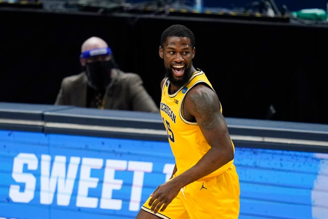Michigan guard Chaundee Brown reacts after making a basket during the first half.