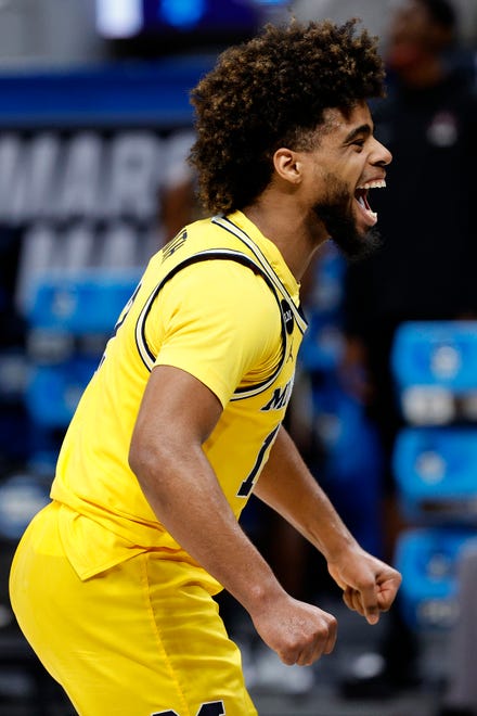 Michigan's Mike Smith celebrates after defeating Florida State in their Sweet Sixteen game.