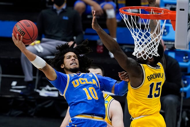 UCLA guard Tyger Campbell (10) shoots over Michigan guard Chaundee Brown (15) during the second half.