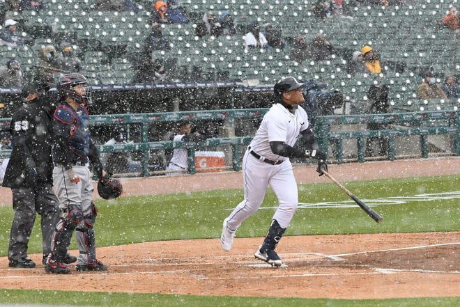 Tigers' Miguel Cabrera watches the flight of his two-run homer in the first inning on Opening Day against the Cleveland Indians at Comerica Park in Detroit on April 1, 2021. The snow was flying in the first inning.
