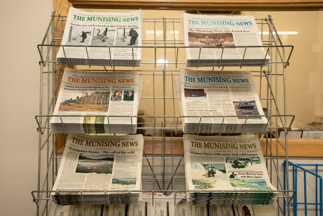 Weekly issues of The Munising News sit on racks inside the newsroom on Tuesday, March 30, 2021.