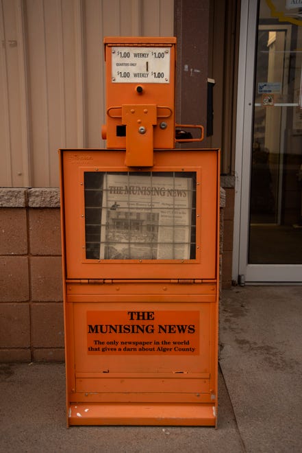 Included above The Munising News banner and on the front of the orange newspaper vending boxes on Tuesday, March 30, 2021 are these words, "The Munising News, The only newspaper in the world that gives a darn about Alger County."