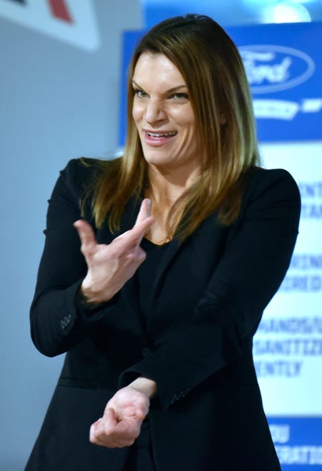 Regional Interpreting Network owner Bethany James signs American Sign Language during an event at Ford Field on Tuesday, April 6, 2021 where Gov. Gretchen Whitmer received her first dose of COVID-19 vaccine.